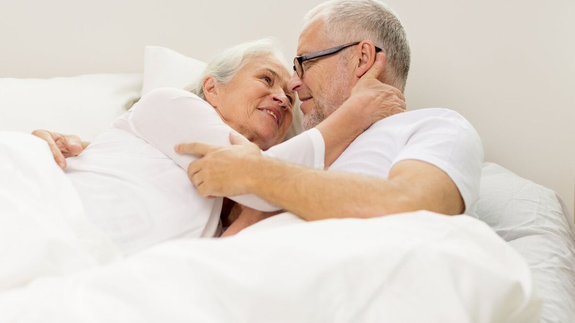Mature couple in bed and person with increased ability